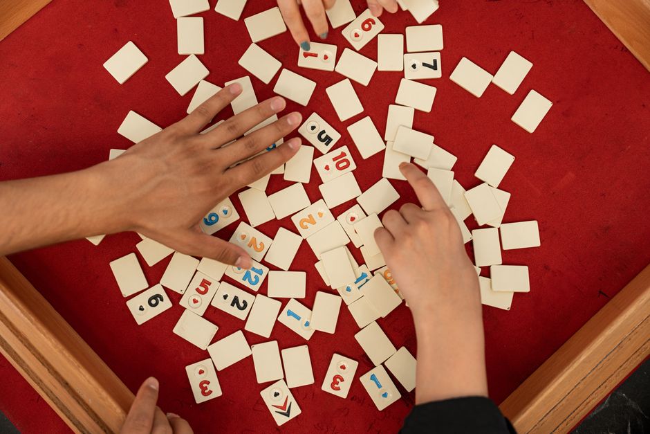 A group of varying size playing a board game together