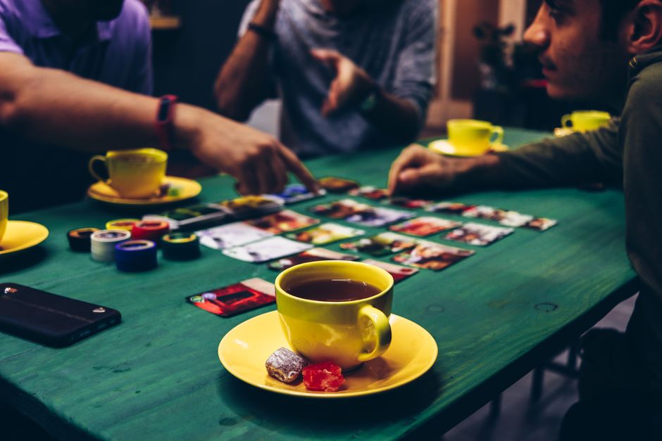 Players discussing a board game rules dispute at the table