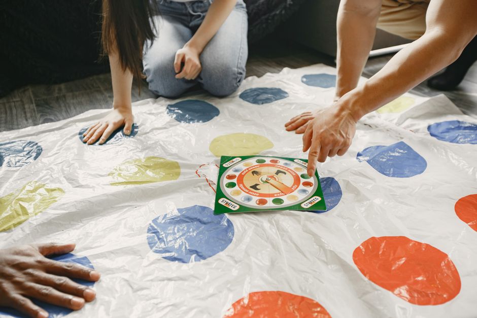 A large group of people playing a party board game together