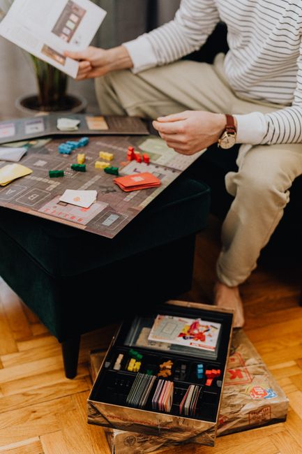 A person reading a board game rulebook before playing